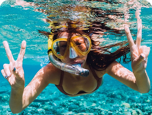 A woman snorkeling in the ocean while visiting Cabo San Lucas on a Santa Maria Snorkel Cruise with Best Cabo Yachts